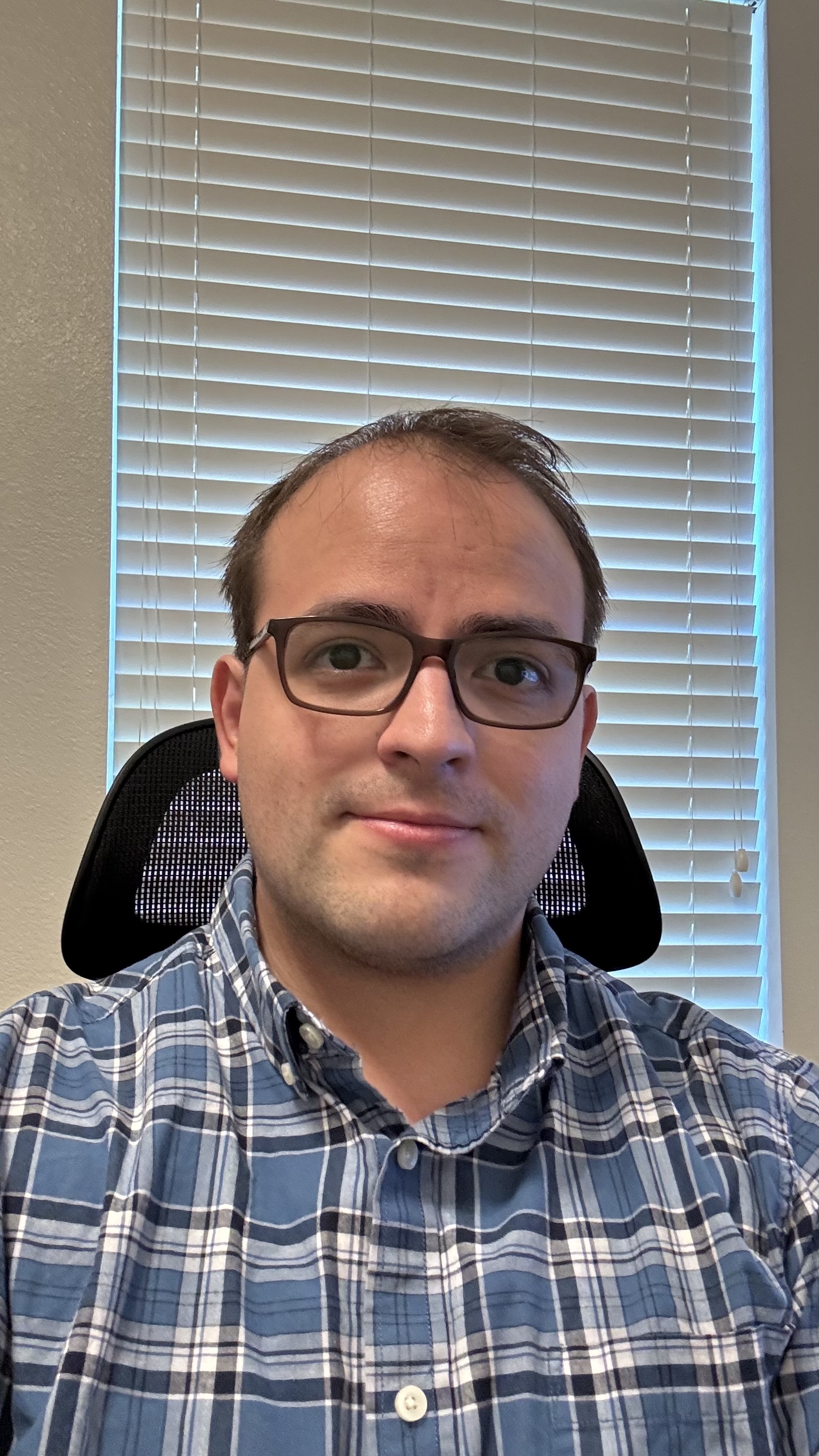 Professional headshot of Alan Roman, Game Designer and Producer, smiling at the camera